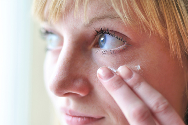Woman applying face cream