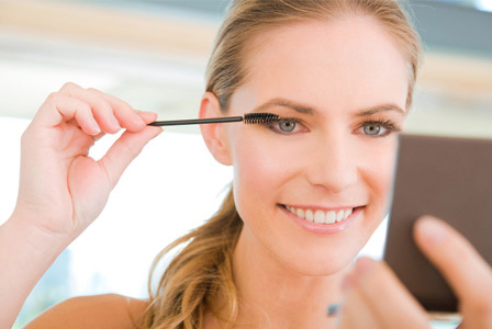 Woman applying eye makeup