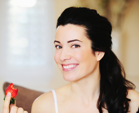 woman eating strawberry