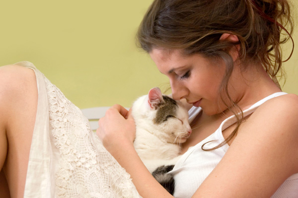 woman cuddling cat