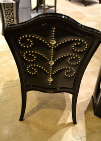 Nailheads placed in a pattern design make the back of this black chair special.