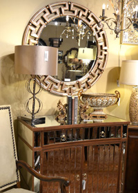 A mirrored table, decorative mirror, and metalic accents makes this vignette shine.