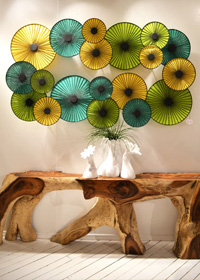 An organic-shaped side table gets a modern update with a blue and green parasol wall light.