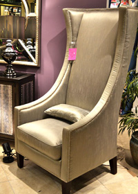 This Winmark Empress Chair features metallic nailheads that are repeated on the side-table and have a similar pattern in the mirror.