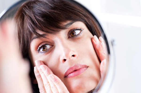 Woman looking in mirror