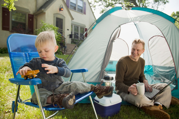 Father and son camping outside home