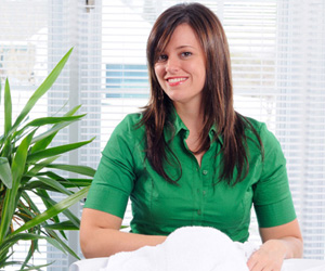 Woman doing laundry with green cleaning supplies