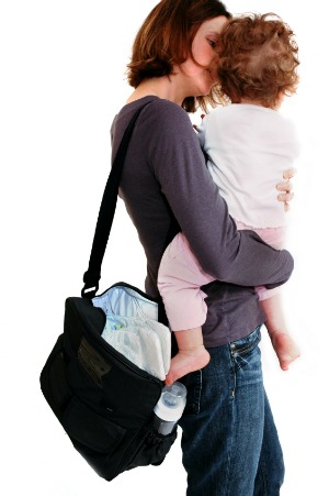 mom holding toddler with diaper bag on shoulder