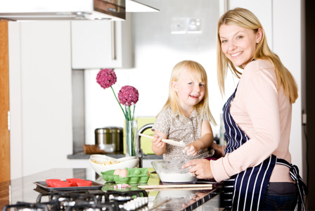 Mom and toddler baking together