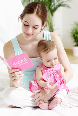 new mom holding baby and mothers day card