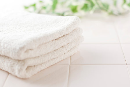 Organic bath towels on white tile
