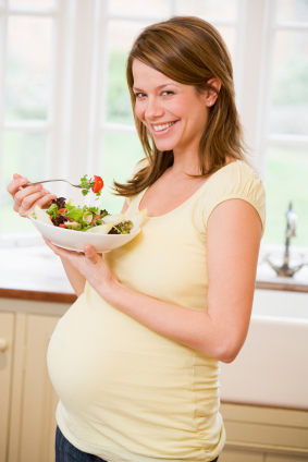 Pregnant woman eating salad