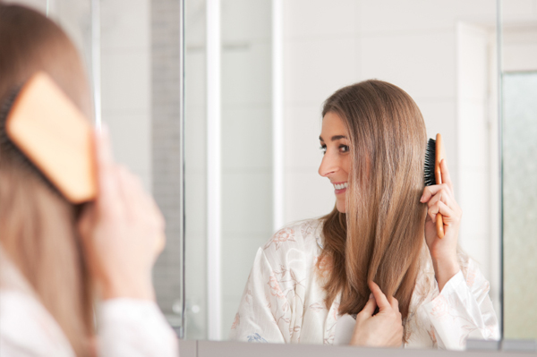 Woman brushing her hair at night