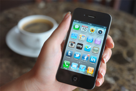 Woman budgeting with iPhone app