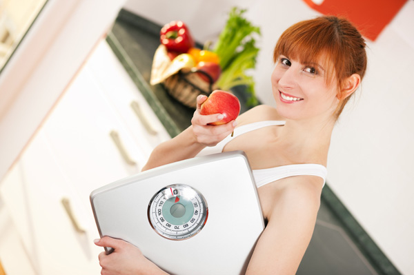 Woman on scale with apple