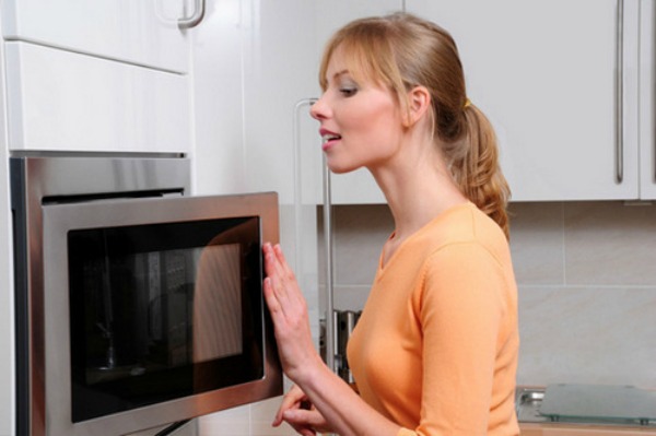 Woman opening microwave