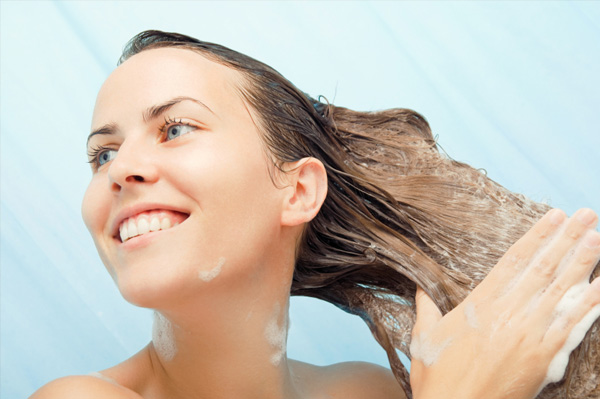 Woman shampooing her hair in the shower