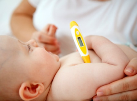 Taking baby temperature with thermometer