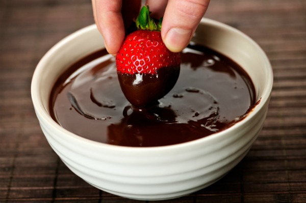 Dipping strawberry in chocolate