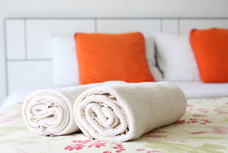 Guest bedroom with towel on bed