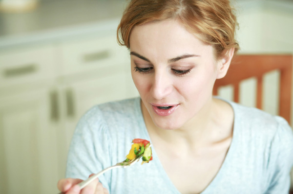Woman eating salad