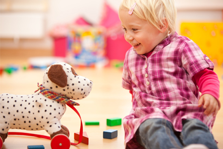 Little girl playing with toys