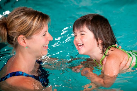 Mother and daughter swimming