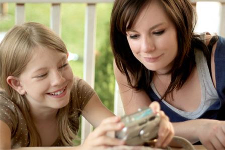 Mom and daughter looking at photos on camera