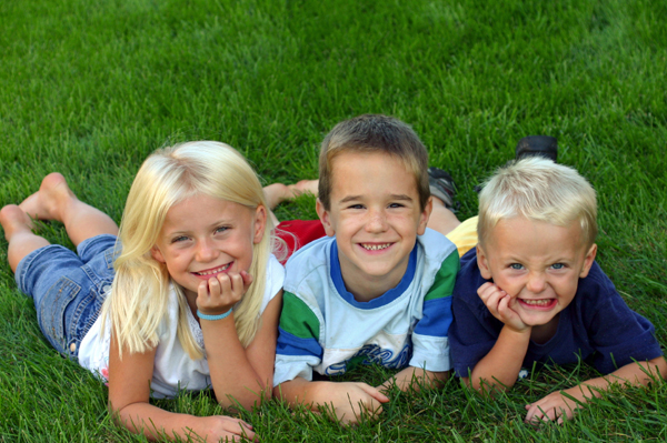 Kids playing in the grass in the summer