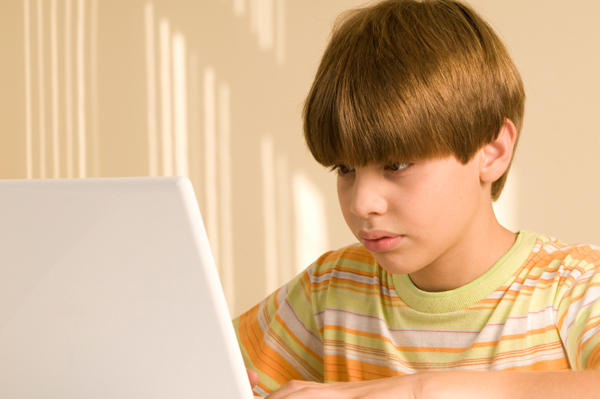 tween boy on laptop