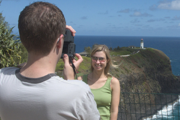 man taking a photo of wife on vacation