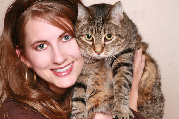 woman cuddling cat
