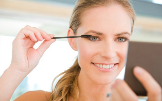 Woman applying mascara
