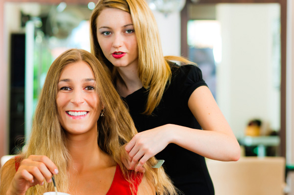 Woman getting haircut in salon