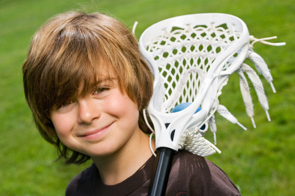 happy, healthy boy playing lacrosse