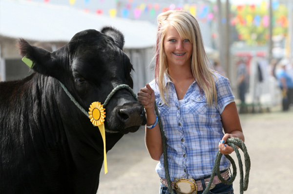 Girl with steer at county fair