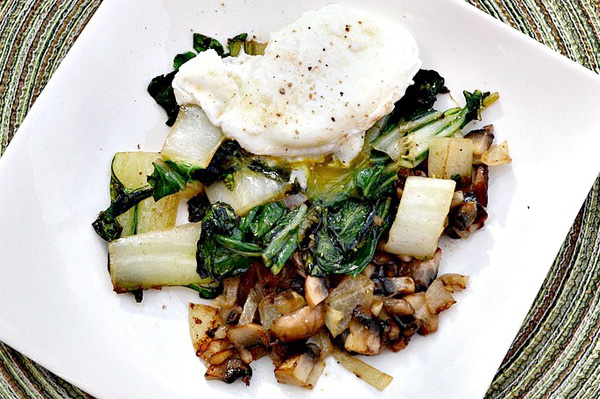 Poached egg served over bok choy