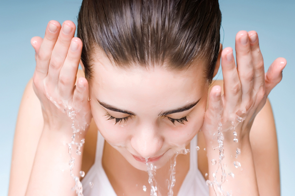 Woman rinsing her face