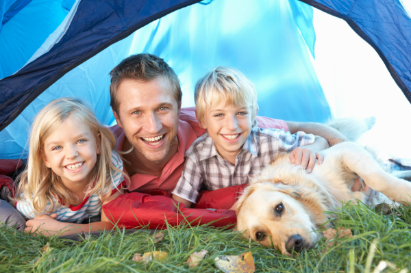 young family camping with their dog