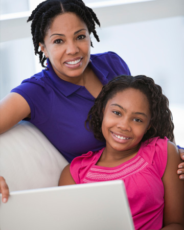 Mom and tween girl on computer