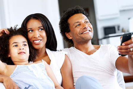 Mom, dad and daughter watching movie