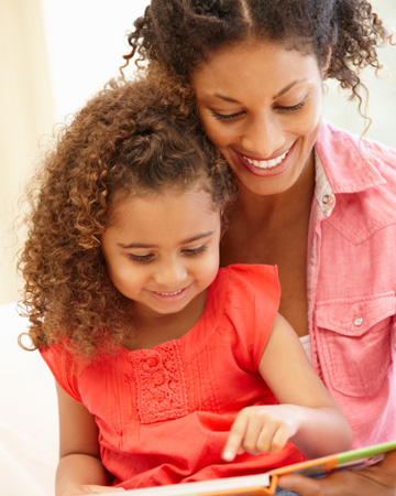 Mom reading book to daughter