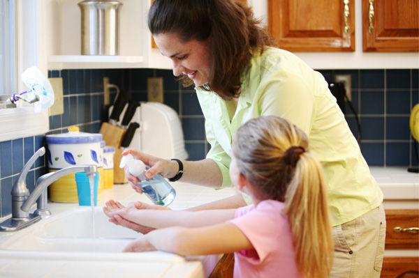 mom and daughter washing hands together