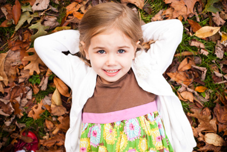 Little girl wearing a cardigan in the fall