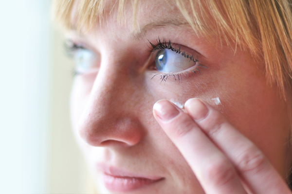 Woman applying eye cream