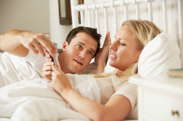 Woman on smartphone in bed