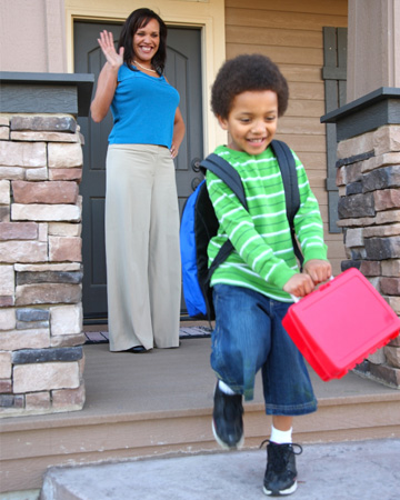 Boy leaving for school with lunchbox