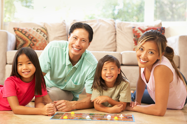 family playing board game together