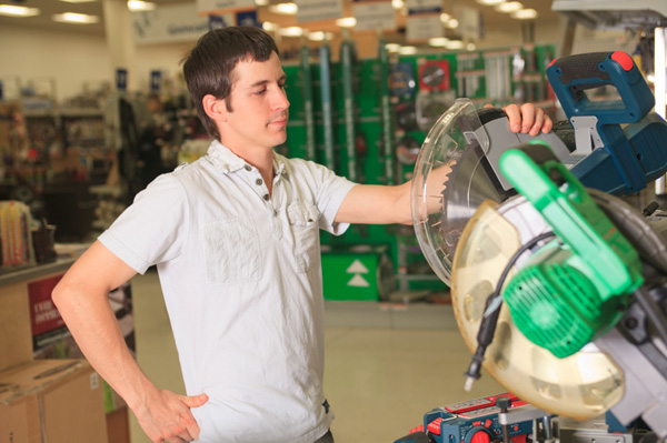 Man looking at saw