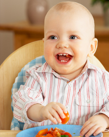 Toddler eating fruit and veggies